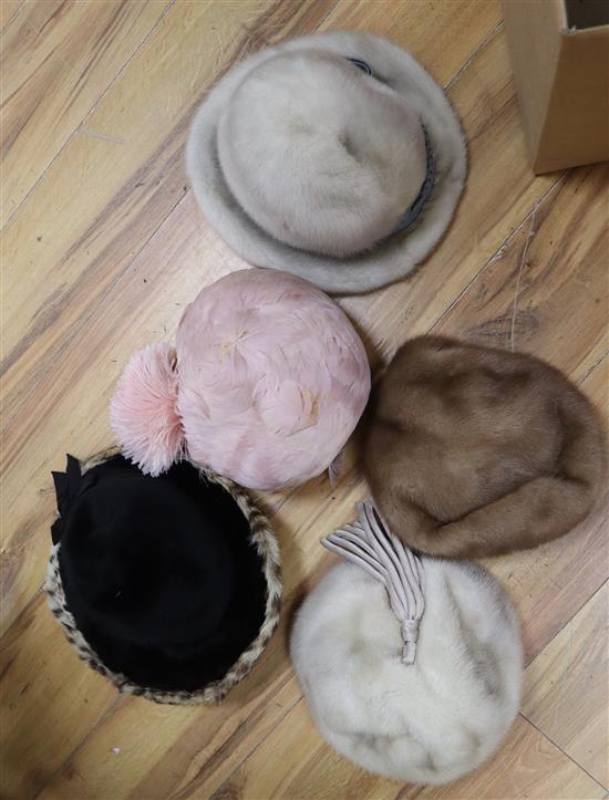 A pink feather hat and four various hats, three being mink